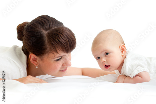 Photo: joyful mother playing with her baby infant joyful mother playing with her baby infant