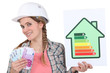 Woman holding energy score card and cash