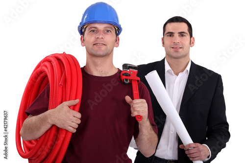 Photo: Tradesman posing with an engineer Tradesman posing with an engineer