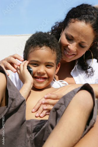 Photo: Mother and son sat outside with mobile Mother and son sat outside with mobile