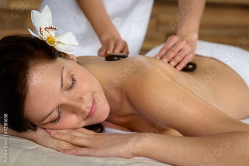 Photo: Hot stone massage woman enjoy spa treatment Hot stone massage woman enjoy spa treatment