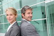 Business people standing back to back