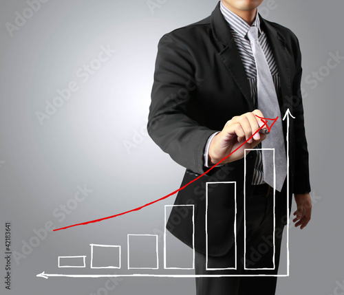Photo: Business men hand drawing a graph growth Business men hand drawing a graph growth