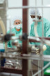 Staff and researchers checking equipment in biotech industry