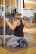 junger Mann im Fitnessstudio trainiert seinen Latissimus