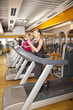 junge Menschen beim Training auf Laufbändern im Fitnessstudio