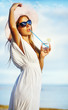 Woman having rest on beach and enjoying a fresh cocktail summer