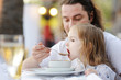 Father feeding his little girl