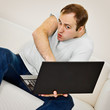 Comic man plays on a laptop
