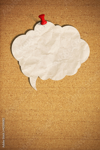 Photo: blank speech bubble note paper with push pins on cork board blank speech bubble note paper with push pins on cork board