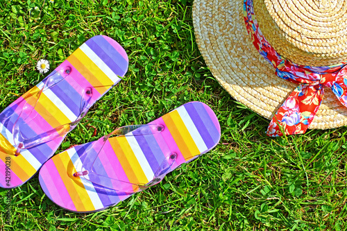 Photo: Colourful flip flops and a straw hat Colourful flip flops and a straw hat
