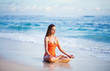 woman on beach doing yoga