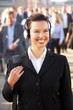 Photo: Female commuter in crowd wearing headphones Female commuter in crowd wearing headphones