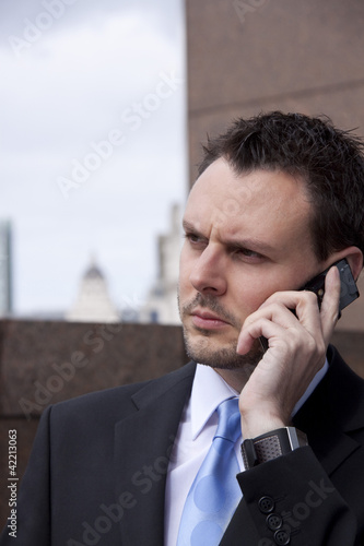 Photo: man listening on mobile phone man listening on mobile phone