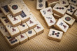 Old chinese game mahjongg on bamboo mat background