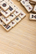 Old chinese game mahjongg on bamboo mat background