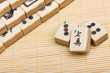 Old chinese game mahjongg on bamboo mat background