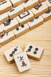 Old chinese game mahjongg on bamboo mat background