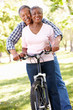 Senior  couple cycling in park