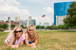 Two woman friends lying on the grass