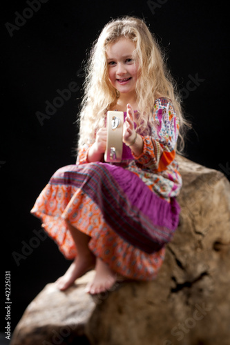 Photo: Cute girl playing tamburine Cute girl playing tamburine
