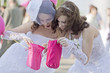Photo: Two girls in a white dress look in pink sacks Two girls in a white dress look in pink sacks