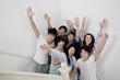 Group of young friends raising arms