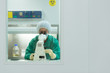 Woman at work with microscope in biotechnology laboratory