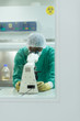 Man at work with microscope in biotechnology lab