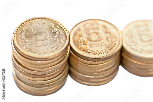 Photo: Close up of Indian Coin stack 5 rupees isolated copy space Close up of Indian Coin stack 5 rupees isolated copy space