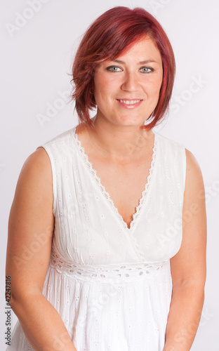 Photo: Red headed woman in white Red headed woman in white