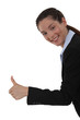 Smiling woman giving the thumb's up