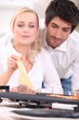 Couple cooking surf and turf on a tabletop hotplate
