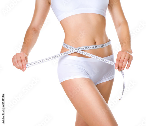 Photo: Woman measuring her waistline. Perfect Slim Body Woman measuring her waistline. Perfect Slim Body
