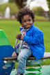 Outdoor portrait of a black baby  playing at playground