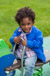 Outdoor portrait of a black baby playing at playground