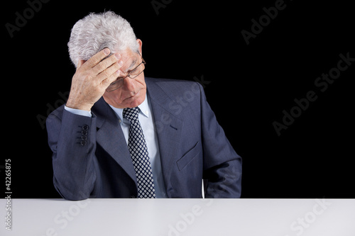 Photo: Headache on a senior businessman Headache on a senior businessman