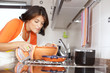Woman cooking at her kitchen