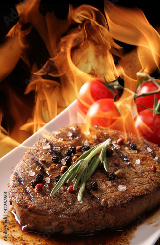 Photo: Grilled meat with fire flames Grilled meat with fire flames