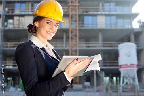 Photo: Female construction engineer / architect with a tablet computer Female construction engineer / architect with a tablet computer