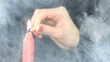 Candle is lighted on black in smoke