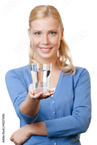 Photo: Young girl with glass of water over white background Young girl with glass of water over white background
