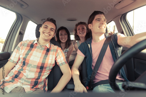 Photo: Four Friends in a Car Leaving For Vacation Four Friends in a Car Leaving For Vacation