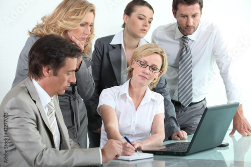 Photo: Businessteam around a laptop Businessteam around a laptop