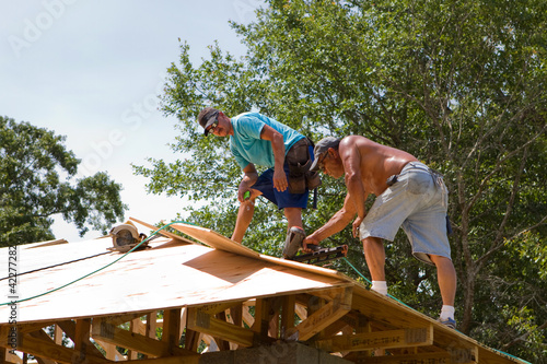 Photo: Carpenters Nailing Plywood Carpenters Nailing Plywood