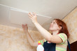 Girl glues ceiling tile