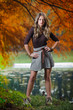 Portrait of attractive blonde girl in the forest in a autumn day