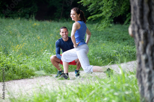 Photo: Personal trainer working with his client, showing her how to pro Personal trainer working with his client, showing her how to pro