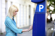 Girl at parking ticket machine