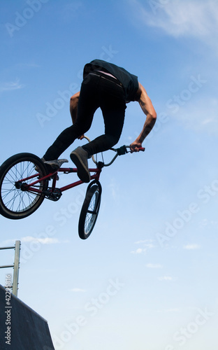 Photo: BMX bicycler over ramp BMX bicycler over ramp